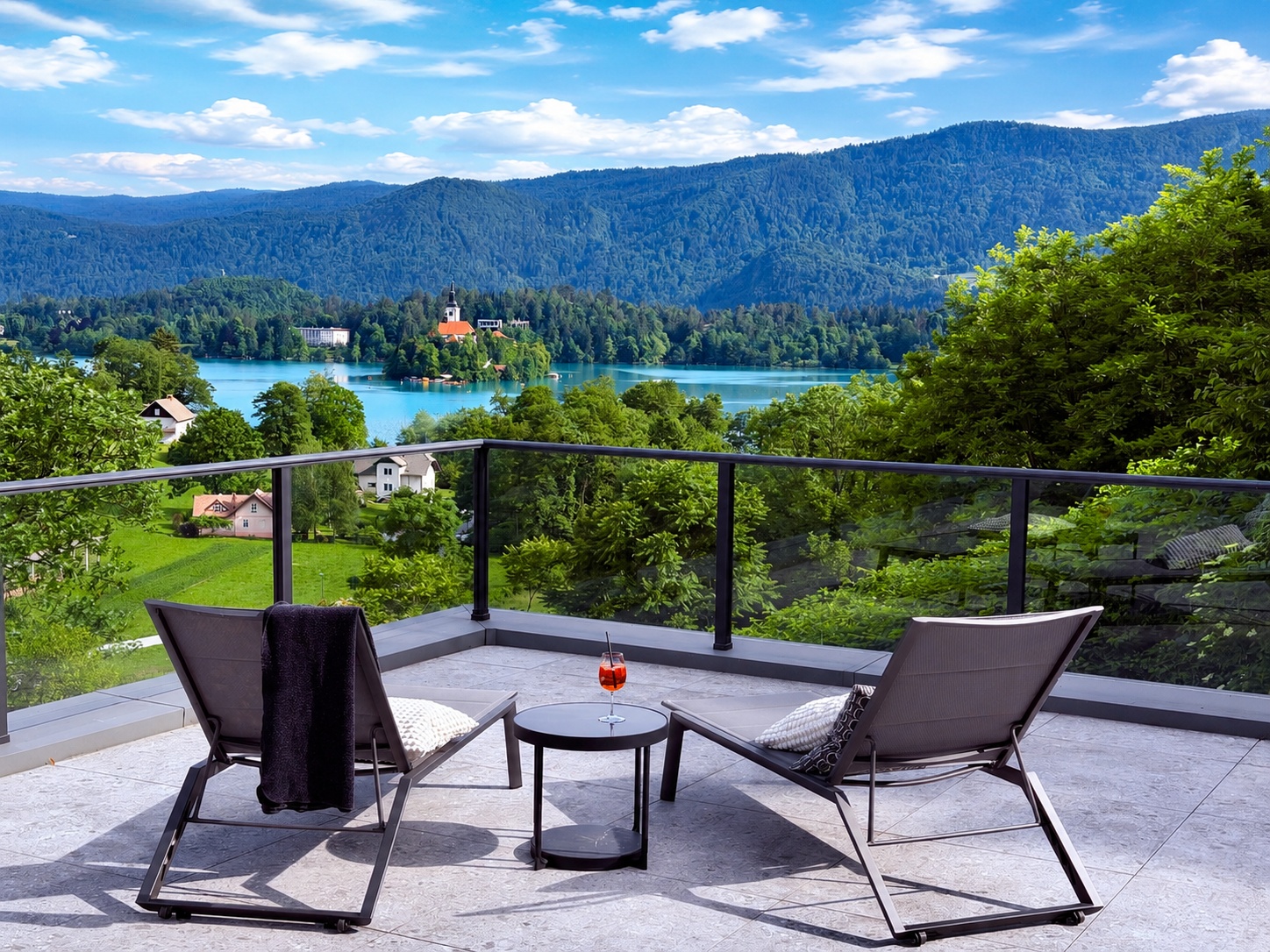 Private terrace overlooking Lake Bled with two lounge chairs